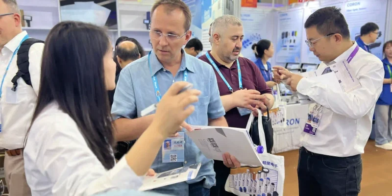 1776221753 durmapress technical discussion with clients at canton fair booth scaled